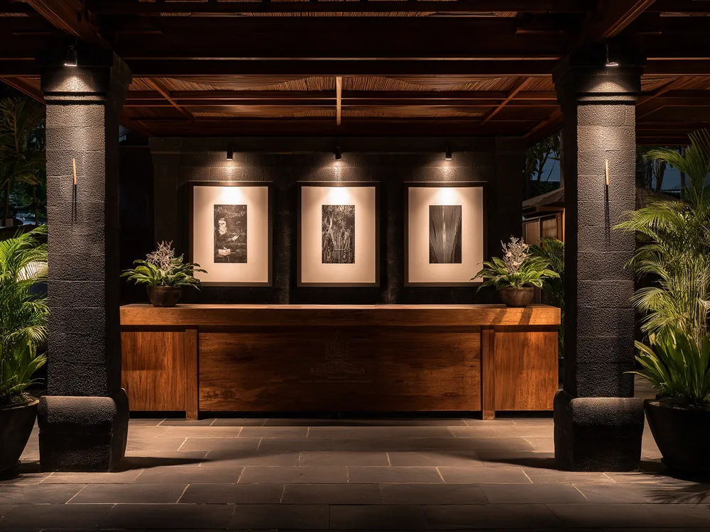 Three Ginko displays installed and lit above a hotel reception desk.